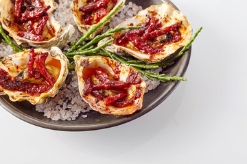 Plate of Oysters Kilpatrick on White Background