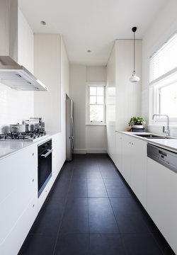 Vertical Of A Long Galley Style Monochrome Kitchen