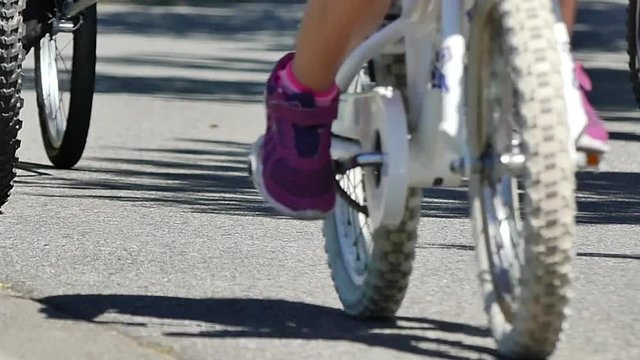 Girl riding bicycle  white wheels