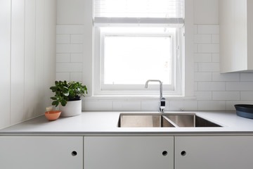 Close up details of contemporary white kitchen with subway tiles