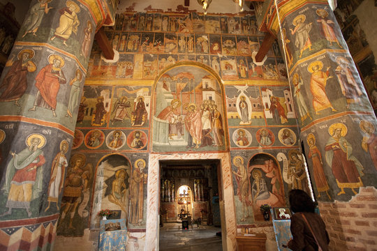 Doorway and columns in orthodox church with romanesque frescoes, Bucharest, Romania