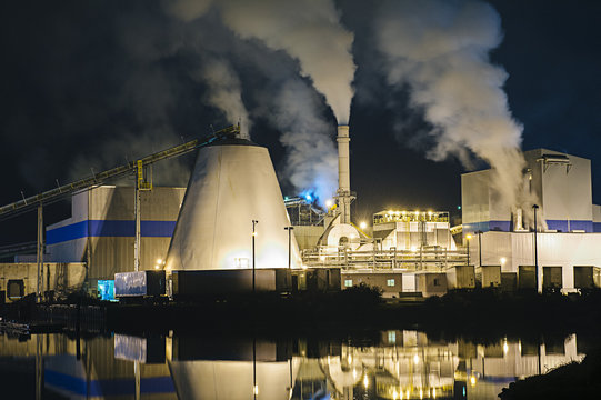 View of pulp mill and smokestacks on waterfront at night, Strait of Juan de Fuca, Port Angeles, Washington State, USA