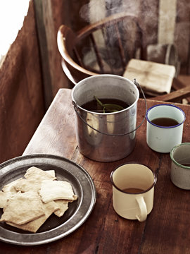Rustic table with billycan tea and biscuits
