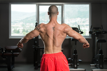 Healthy Young Man Flexing Muscles