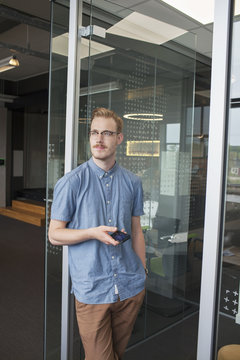 Young Man Gazing From Office Doorway