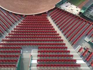 Rows of red seats at a baseball stadium © jhlemmer