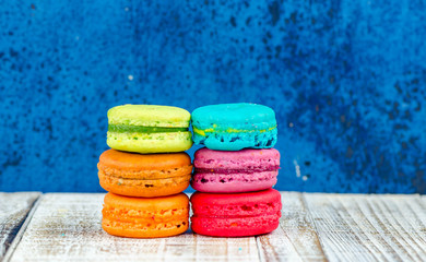 Colorful macarons on vintage pastel background. Macaron or Macar