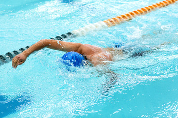 Young athletic man with butterfly swimming technique.