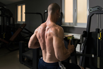 Muscular Man Doing Heavy Weight Exercise For Back