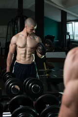 Fototapeta na wymiar Biceps Exercise In Front Of A Mirror