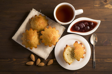 Sweet lush cupcake with strawberry jam and tea