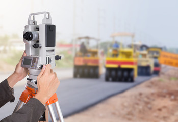 hand working with survey equipment theodolite on a tripod. with