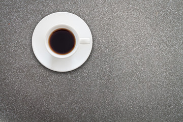Close up white coffee cup on glitter texture