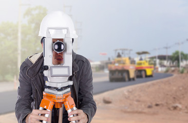 engineer working with survey equipment theodolite with road unde