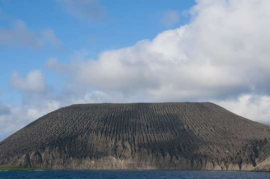 View of San Benedicto Island with ash formation along the crater of its inactive volcano, Revillagigedo, Mexico