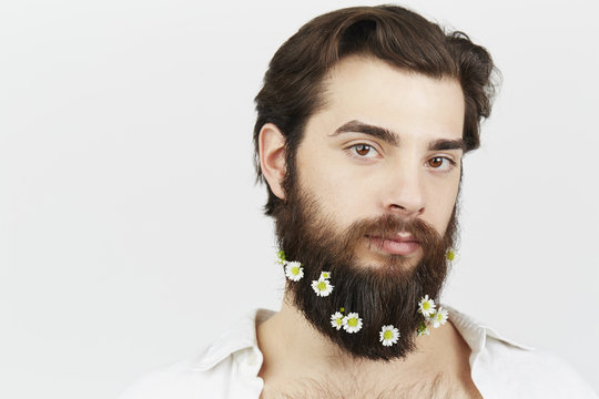 Portrait of man with flowers in beard