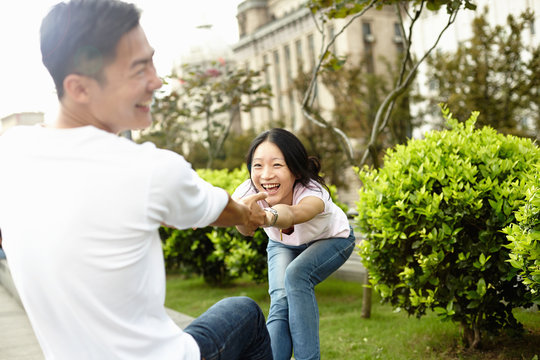 Tourist couple  laughing and dancing, The Bund, Shanghai, China