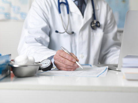 Doctor checking medical notes before prescribing treatment