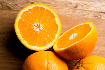 Three Fresh Oranges cut in half