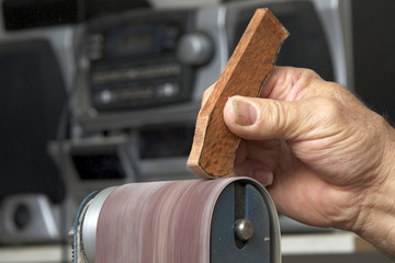 Using a belt sander, close up