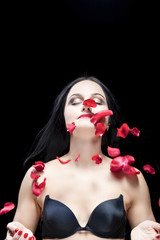 Portrait of Caucasian Brunette Woman With Flying Rose Petals