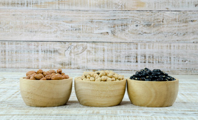 Fototapeta na wymiar A variety of nuts in a cup on a wooden background.