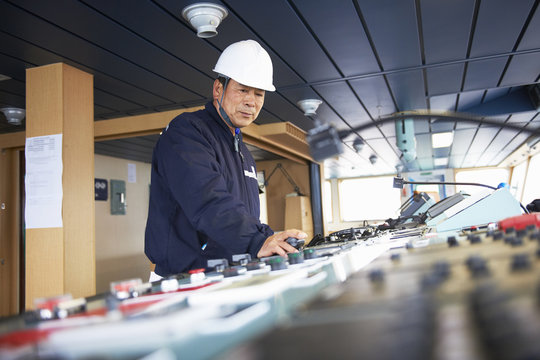 Worker using equipment at shipping port, GoSeong-gun, South Korea
