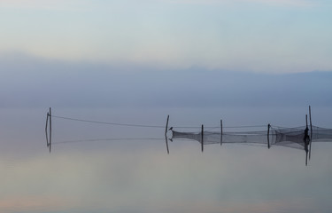 Fishing nets in the morning fog Photo taken at Arresø, Denmark.