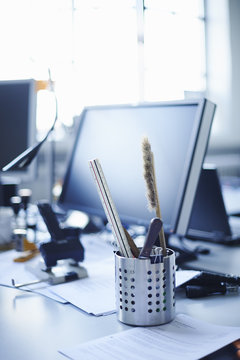 Desk tidy and personal computer on office desk