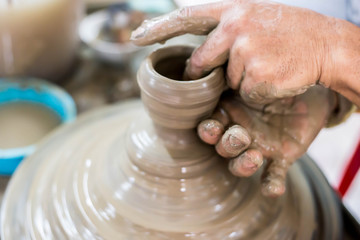 Fototapeta na wymiar Clay potter creating on the pottery wheel
