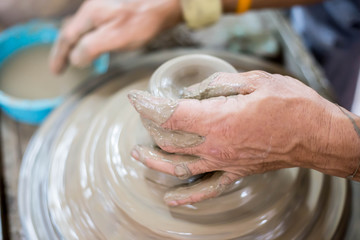 Clay potter creating on the pottery wheel