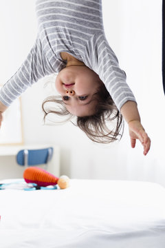 Baby boy hanging upside-down
