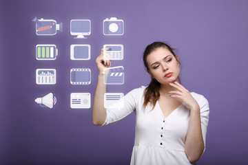 Woman pressing multimedia and entertainment icons on a virtual background