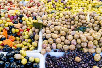 Olives, chilies, preserves in a French market in Paris, France