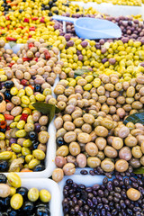 Olives, chilies, preserves in a French market in Paris, France