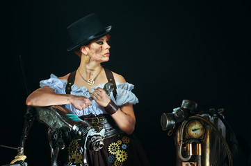 Fototapeta na wymiar Steam-punk portrait of the girl with the mechanisms on a dark background