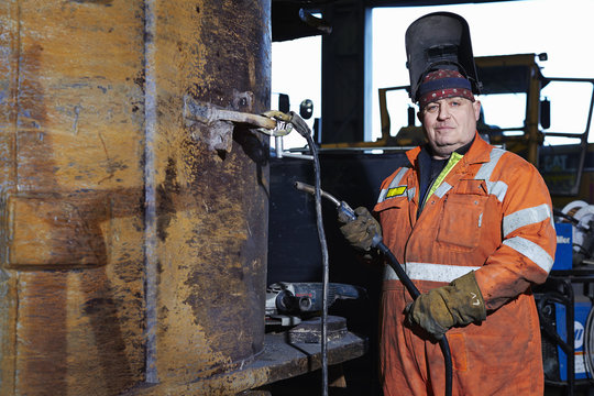 Portrait of mature welder in quarry workshop