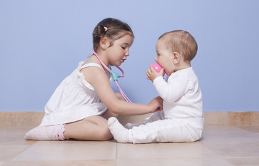 Brothers playing doctor with stethoscope