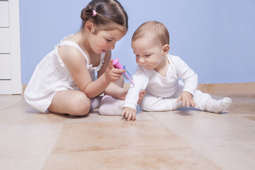 Brothers playing doctor with syringe