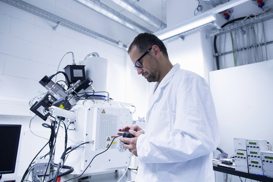Lab assistant working on equipment