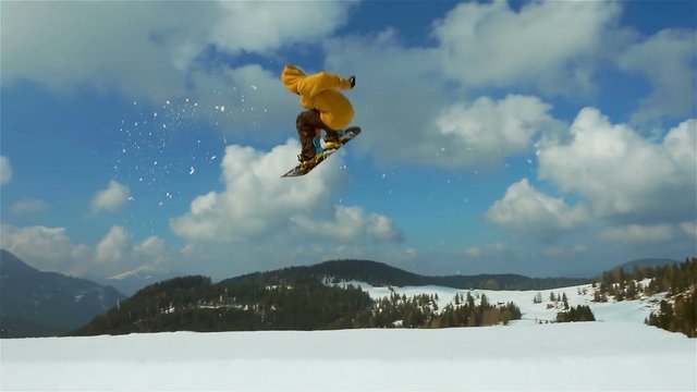 snowboard slow motion,snowboarder jumps backside slow motion