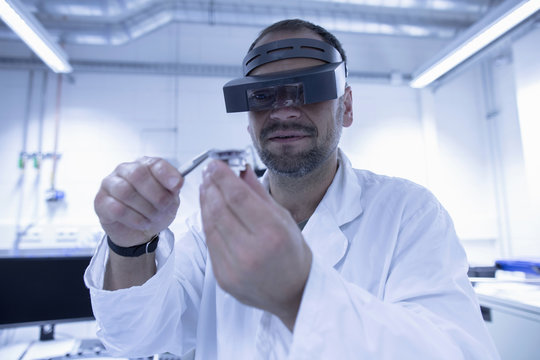 Lab assistant fixing part