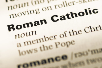 Close up of old English dictionary page with word roman catholic