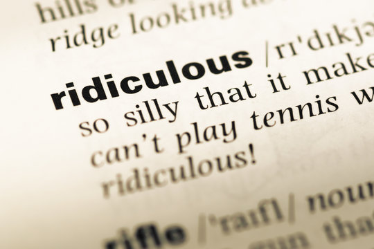 Close up of old English dictionary page with word ridiculous