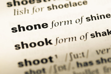 Obraz premium Close up of old English dictionary page with word shone