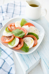 Fresh salad with tomatoes, a mozzarella and a basil