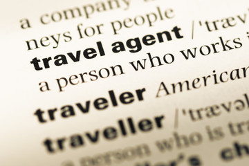 Close up of old English dictionary page with word travel agent