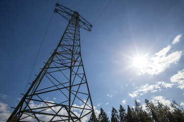 high power pylon and the sun