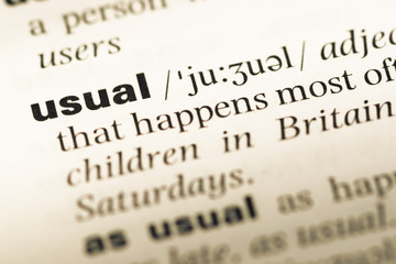 Close up of old English dictionary page with word usual