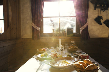 Sunlit breakfast table in log cabin